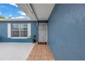 Welcoming covered front porch with tiled walkway and a secure metal gate at 2270 Amherst Ave, Spring Hill, FL 34609