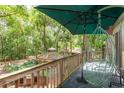 Relaxing covered deck area with views of the gazebo and wooded backyard at 2279 Ranchette Ln, Dunedin, FL 34698
