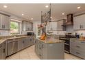 Modern kitchen with granite countertops, stainless steel appliances, and ample cabinet space at 2279 Ranchette Ln, Dunedin, FL 34698