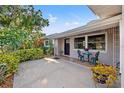 Inviting front porch features a cozy seating area, potted plants, and a charming entryway, adding character to the home at 2701 65Th Ave S, St Petersburg, FL 33712