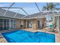 Enclosed swimming pool surrounded by patio seating, offering a relaxing outdoor oasis at 332 Wood Dove Ave, Tarpon Springs, FL 34689
