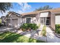 Charming single-story home with a one-car garage, well-maintained landscaping, and an inviting front entrance at 35229 Janine Dr, Zephyrhills, FL 33541