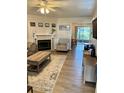 Bright living room with a fireplace, neutral decor, and sliding glass doors to the outside at 3615 Pine Knot Dr, Valrico, FL 33596