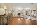 Formal dining area featuring wood floors, an elegant chandelier, and lots of natural light at 3922 Cedar Cay Circle, Valrico, FL 33596