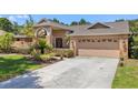 Well-maintained single-story home featuring brick accents, neutral stucco and a two-car garage in a landscaped yard at 3922 Cedar Cay Circle, Valrico, FL 33596