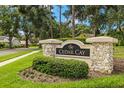 Stone community entrance sign for Cedar Cay lined with green shrubbery in a peaceful neighborhood at 3922 Cedar Cay Circle, Valrico, FL 33596