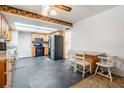 Kitchen with tile flooring, stainless steel appliances, wood cabinets, breakfast table, and ample natural light at 414 Cactus Cir, Seffner, FL 33584