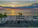Scenic aerial view of a beach park with picnic areas, parking, and a beautiful sunset over the ocean at 4408 Rudder Way, New Port Richey, FL 34652