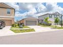 Inviting home exterior showcases a two-car garage, driveway, and a beautifully maintained front yard at 4507 Eternal Prince Dr, Sun City Center, FL 33573
