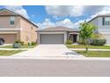 Exterior shot showcasing a two-car garage, driveway, and attractive landscaping adding curb appeal at 4507 Eternal Prince Dr, Sun City Center, FL 33573