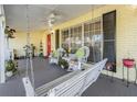 Inviting front porch featuring rocking chairs and a swing for relaxing outdoors at 4509 S Cortez Ave, Tampa, FL 33611