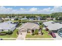 Aerial view of a home in a community with a lake and well-maintained lawns at 5049 Rushbrook Rd, Land O Lakes, FL 34638
