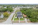 An aerial perspective showcases the home's layout, surrounded by lush trees and neighboring buildings at 5055 2Nd S Ave, St Petersburg, FL 33707