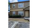 Close up of the townhome, showcasing manicured landscaping and reserved parking at 5915 Brickleberry Ln # 103, Zephyrhills, FL 33541