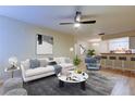 Bright living room boasts an open floor plan with modern furnishings and a ceiling fan at 5915 Brickleberry Ln # 103, Zephyrhills, FL 33541