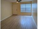Bright living room with neutral walls, modern ceiling fan, and wood-look flooring at 5915 Brickleberry Ln # 103, Zephyrhills, FL 33541