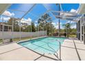 Inviting screened-in pool with clear blue water and ample deck space for lounging at 6129 Schalekamp Dr, Spring Hill, FL 34609