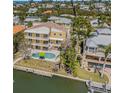 Stunning aerial view of waterfront property with private pool, lush landscaping and beautiful dock at 614 Norton St, Longboat Key, FL 34228