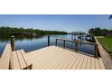 Private wooden dock with seating overlooking the serene waterway, perfect for boating enthusiasts at 671 Tallahassee Ne Dr, St Petersburg, FL 33702