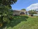 Charming single-story home with a well-manicured lawn and colorful landscaping at 700 Bowsprit Pl, Palm Harbor, FL 34685