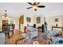 Comfortable living room with neutral walls, wood flooring, and an area rug that brings color to the space at 700 Bowsprit Pl, Palm Harbor, FL 34685