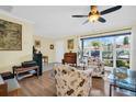 Bright living room featuring hardwood floors, a large window, and a comfortable seating area at 700 Bowsprit Pl, Palm Harbor, FL 34685