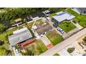 This aerial view displays the property's backyard, boat lift, and neighborhood at 825 Seabreeze Dr, Ruskin, FL 33570