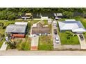 Aerial shot displaying the property lines, boat lift, backyard, and neighborhood at 825 Seabreeze Dr, Ruskin, FL 33570