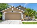 Two car garage on a well maintained one story home with nice landscaping at 8504 Tidal Bay Ln, Tampa, FL 33635