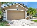 Spacious garage on a one story home with a well-maintained lawn at 8504 Tidal Bay Ln, Tampa, FL 33635