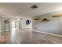 Open-concept living room featuring neutral walls, modern tile flooring, and abundant natural light, creating a bright and airy space at 9120 Lunar Ln, Port Richey, FL 34668