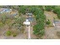 Aerial view of the property featuring a screened-in pool area and ample green space at 9615 Jasmine Blvd, New Port Richey, FL 34654