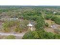 Expansive aerial view showcasing the home's large lot surrounded by lush greenery and mature trees at 9615 Jasmine Blvd, New Port Richey, FL 34654
