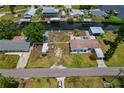 Aerial view of a property showcasing the home's positioning along canal and proximity to neighborhood amenities at 103 W North Branch Rd, Ruskin, FL 33570
