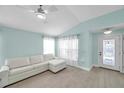 Bright living room with wood flooring, white sectional sofa and natural light at 10431 Frog Pond Dr, Riverview, FL 33569