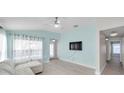 Comfortable living room with light walls, wood flooring and bright natural light at 10431 Frog Pond Dr, Riverview, FL 33569