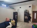 Cozy living room with neutral-toned walls, tiled flooring, and comfortable seating at 10539 Parkcrest Dr, Tampa, FL 33624