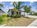 Well-maintained single-story home featuring a spacious driveway, lawn, and landscaping at 10822 Crushed Grape Dr, Riverview, FL 33578
