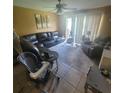 Comfortable living room with a large sectional sofa, tile flooring, and plenty of natural light at 10850 Lake Saint Charles Blvd, Riverview, FL 33578
