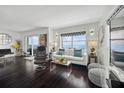 Bright living room featuring hardwood floors, comfortable seating, and expansive windows with water views at 1120 N Shore Ne Dr # 802, St Petersburg, FL 33701