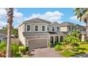 Beautiful two-story house showcasing a well-manicured lawn and a brick-paved driveway at 11419 Emerald Shore Dr, Riverview, FL 33579