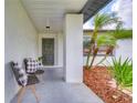 Cozy front porch with seating, a welcoming wreath, and stylish decor at 11520 Bear Paw Ln, Port Richey, FL 34668