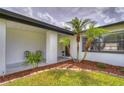 Inviting front entrance with well-maintained landscaping, mulch, and black accents at 11520 Bear Paw Ln, Port Richey, FL 34668