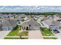 An aerial view of a single Gathering home nestled within a well-maintained neighborhood at 12420 Brick Cobblestone Dr, Riverview, FL 33579
