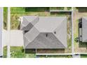 A top-down aerial view of the roof of a residential home with a gray shingle roof at 12420 Brick Cobblestone Dr, Riverview, FL 33579