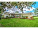 Charming ranch-style home featuring a well-manicured lawn and tasteful landscaping at 2132 Sandpiper Dr, Clearwater, FL 33764
