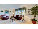 Elegant living room with classic furniture, decorative window treatment, and bright lighting at 2132 Sandpiper Dr, Clearwater, FL 33764