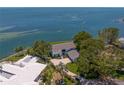 Aerial view of a charming waterfront estate with lush trees and meticulous landscaping at 218 Colony Point S Rd, St Petersburg, FL 33705