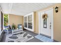 Cozy screened front porch with stylish seating and decor at 2807 Northcote Dr, Palm Harbor, FL 34684
