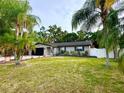 Landscaped single-story home with a spacious yard and black accents at 3143 Phoenix Ave, Oldsmar, FL 34677